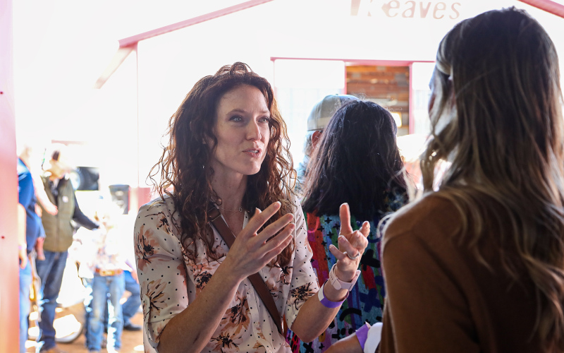 Rebecca Blue (left) shares information about a program to connect, engage and educate women in agriculture and conservation with Dakotafest Woman Farmer/Rancher of the Year nominee Kendra Olson on Aug. 22, 2024, at Dakotafest in Mitchell, S.D.