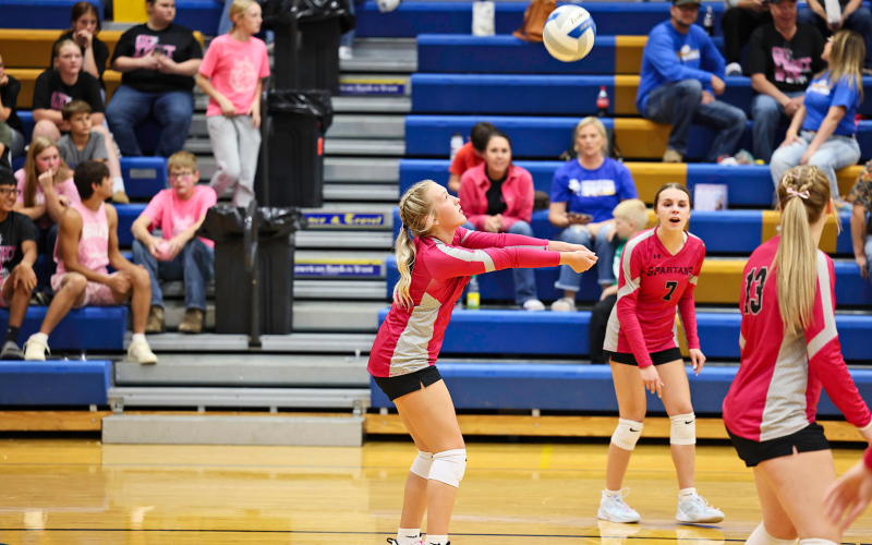 Kendall Kolousek bumps the volleyball over the net.