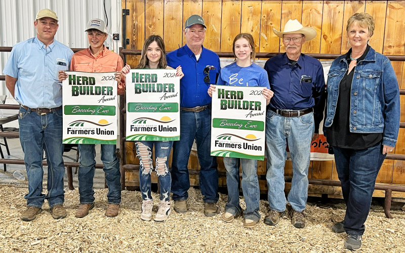 (PHOTO COURTESY SDFU) Rylan Fagerhaug of Wessington Springs, Brooke Lamont of Union Center and Evelyn Bunker of Reliance won breeding ewes through the South Dakota Farmers Union Herd Builder Award presented during the Western Jr. Livestock Show in Rapid City. The Herd Builder winners are pictured here with Rocky Forman, SDFU Member Services Coordinator, David Reis, SDFU Board Member, Dallis Basel, SDFU Board Member and Karla Hofhenke, SDFU Executive Director.