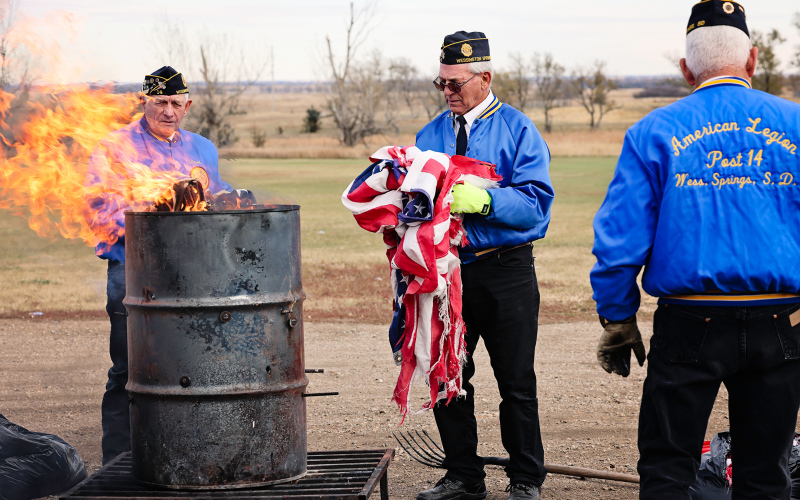 Members of Post 14 retired battered flags by incineration immediately following the program.