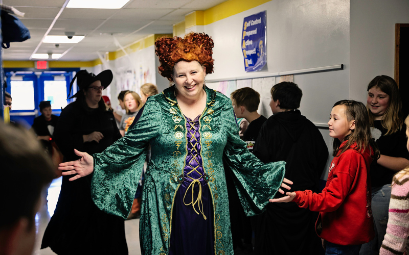 Special Education teacher Terri Moross high fives students as she passes by.