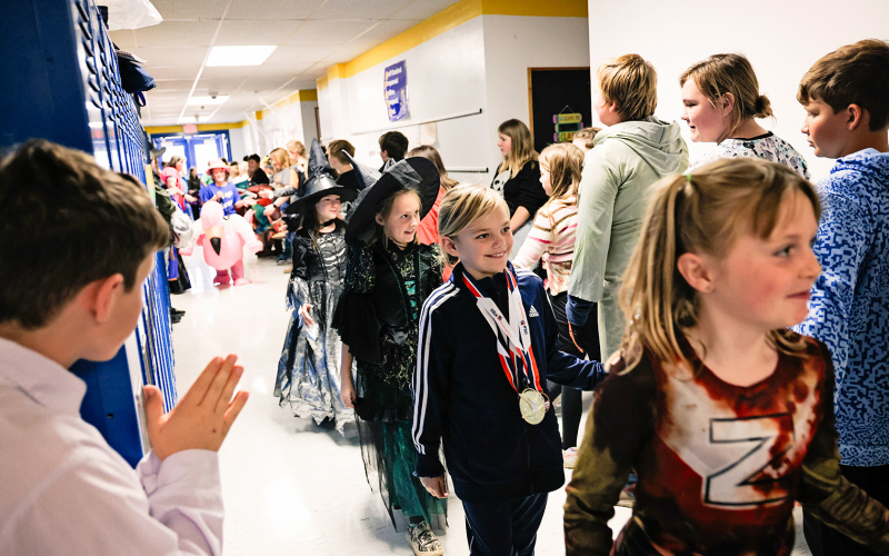 Carlayna Waters, dressed as a gymnast gold medalist smiles as she makes her way through the halls.