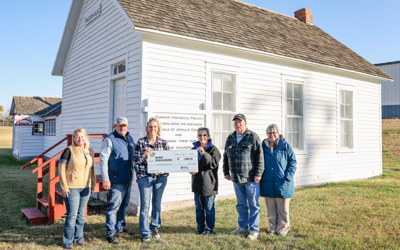 KRISTI HINE / TRUE DAKOTAN Pictured west of the Fagerhaug school house, left to right are: Tara Miller, Manager of Communications, Central Electric Cooperative; Merl Bechen, Operation Round-Up Trustee; Amber Kolousek, Operation Round-Up Trustee; Jean Ferguson, Darell Deneke and Sue Perry, all Dunham Historical Society volunteers.
