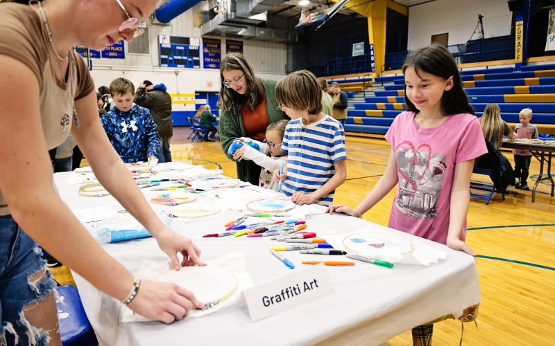 Leelin Polly, Bob and Jocelyn Wenzel enjoy creating their own “graffiti art” at the STEAM event held last month at Wessington Springs Elementary School.