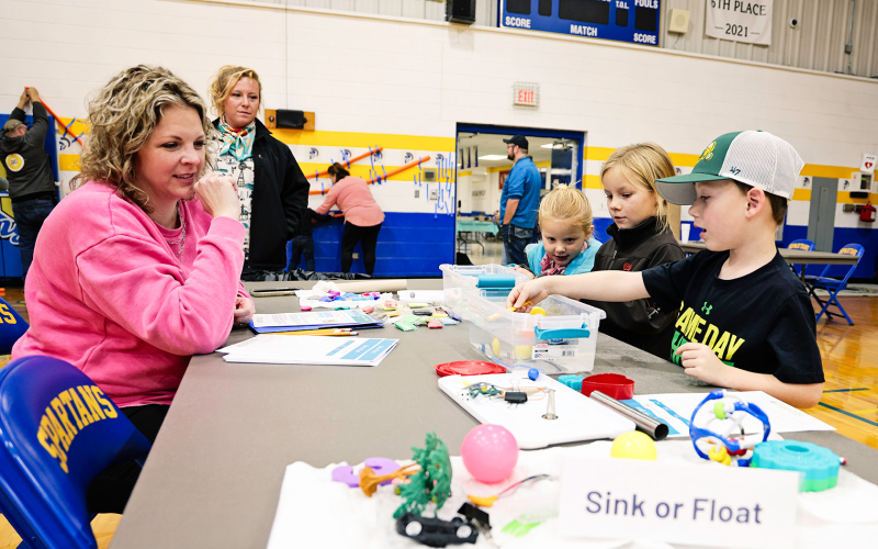 Landon Culver, Presley Wilde and Jana Wilde participate in the "sink or swim" station with elementary school teacher Kim Orth.