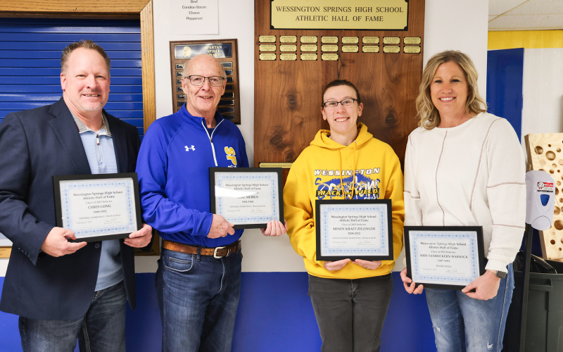 Spartans fans from near and far packed the bleachers over the weekend to welcome the newest inductees to the WSHS Hall of Fame. Representing the fourth annual class of hall-offamers are, left to right, Chris Long, Mike Mebius, Mindy Kraft Zillinger and Kris Vanbockern Warwick.  KRISTI HINE / TRUE DAKOTAN