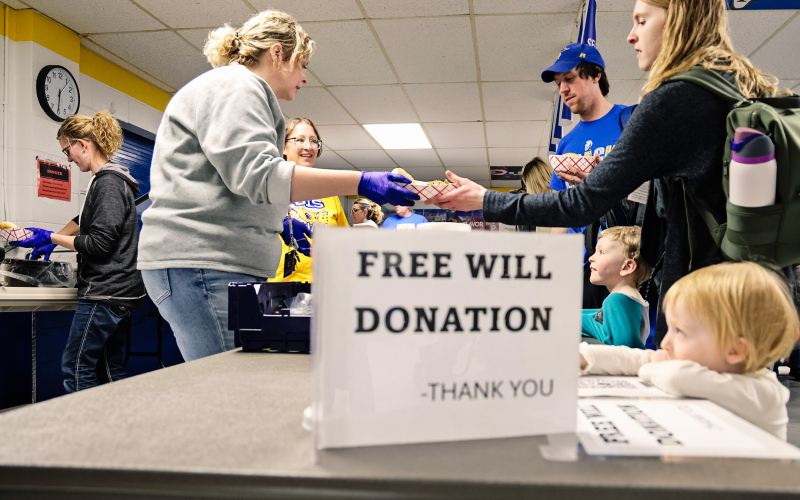 Wessington Springs Elementary School teachers Sarah Larson, Kacee Polly, Becky Krueger and Kim Orth are seen serving the free will donation meal at the benefit to event attendees Drew, Catherine, Asher and Emery Kraft.