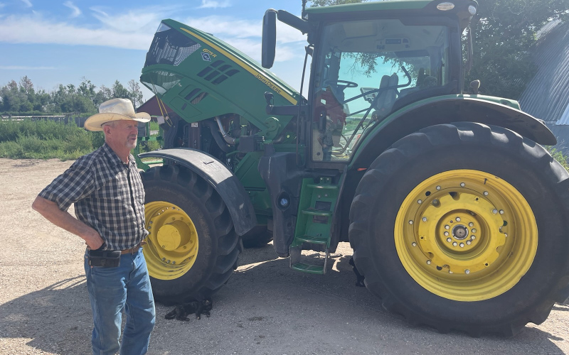 Don Zilverberg, a third-generation cattle rancher in Hyde County, S.D., returns from working the fields to bale alfalfa on July 24, 2023 in Holabird, about 40 miles east of Pierre. (Photo: Stu Whitney / South Dakota News Watch)