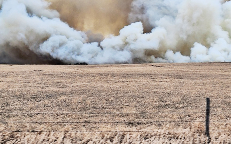 PHOTO COURTESY HELEN HUISMAN Smoke from the weekend wildfire makes its way toward the home of Rod and Helen Huisman. Eight area fire departments were able to contain the blaze, preventing any major damage to structures in the area.