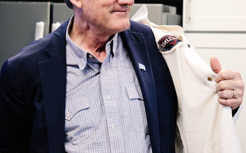 Donning a Jack Link’s coat, Gov. Larry Rhoden prepares to tour the Jack Link’s facility in Alpena Wednesday afternoon, May 14, 2025.
