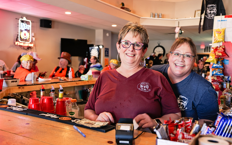 Marci Schimke and Deb Fastnacht served thirsty poker run attendees inside, while Madeline Gran served customers outdoors. T