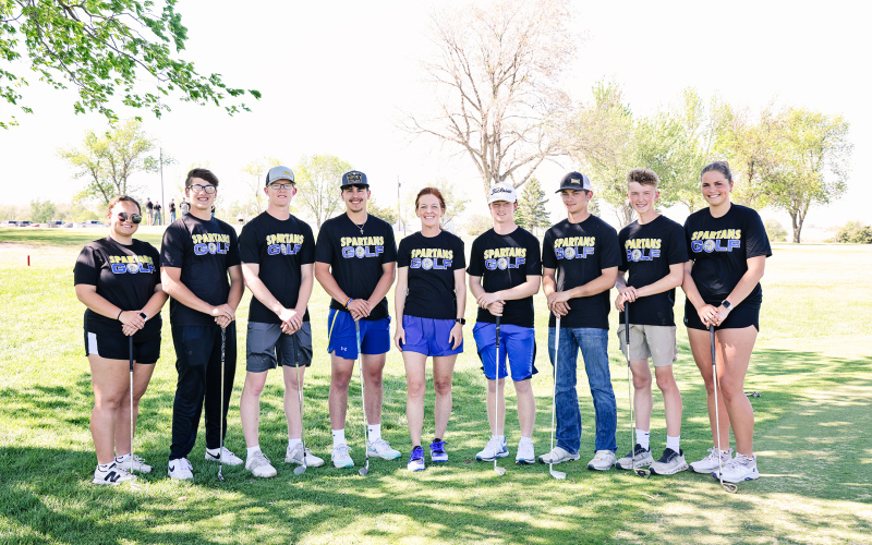 Varsity Spartan golfers, left to right: Taylor Braun, Brett Miller, Luke Larson, Blake Miller, Head Coach Regina Teveldal, JD Thompson, Heyns Bothma, Tucker Thompson, Kaitlyn Braun.