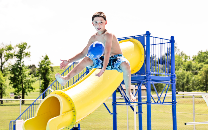 Lorin Schaller of Wessington Springs made an athletic leap off the diving board to catch a football thrown from the deck by Oakley Thompson of Tea.