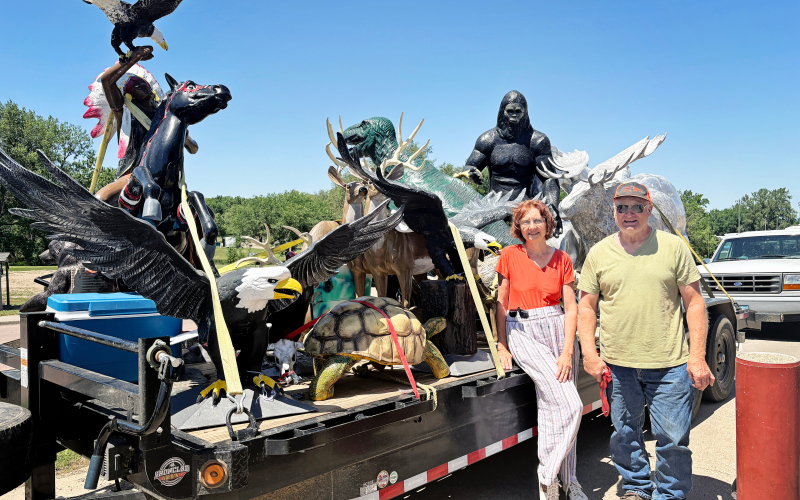 PHOTO: Susan Love and Stanley Tjeerdsma drew curiosity and questions as they passed through Wessington Springs Monday, June 25, 2025 with a trailer load of larger-than-life staues.