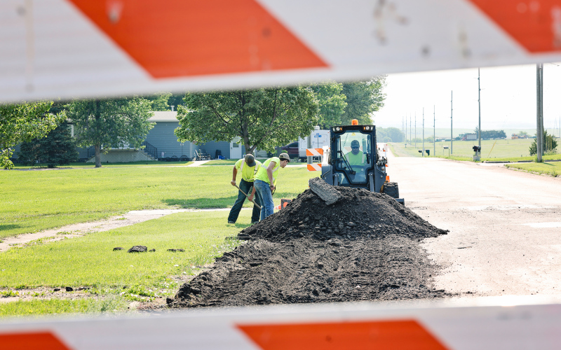 Construction is well-underway across Wessington Springs, including on Main Street East. City employee Lucas VanEngelenburg and summer hires Robert Hine and Karter Mebius work on removing damaged material from the street as a result of heavy semi truck traffic. The prepared section of the street now awaits hot mix installation, designed to bear larger loads than the current surface.