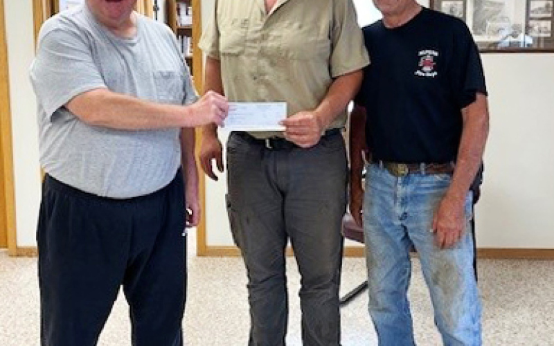 (SUBMITTED) The fundraising total of $3,800 from the Annual Brett Boomer Golf Tournament was presented to firefighter Chris Albrecht, who accepted on behalf of the department. Funds from the event will go toward ongoing equipment upgrades and firefighter training. Shown left to right are: Tournament organizer Todd Boomer, Alpena fireman Chris Albrecht and Alpena fireman Bruce Orth.