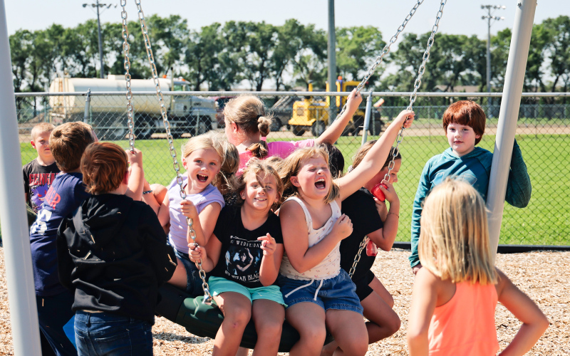Wolsey-Wessington Elementary students make the most of recess on the school’s brand-new playground, the first phase of a $2 million facilities project supported by the community. Construction equipment in the background marks progress on the district’s new track and football field.