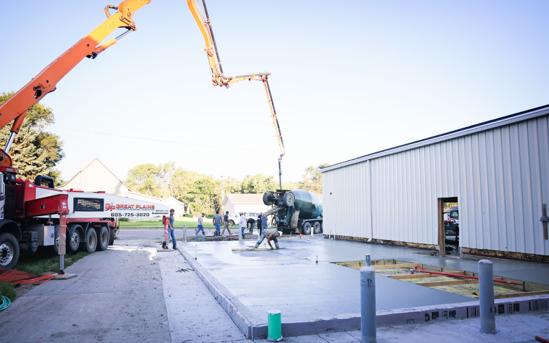 Crews from C. Eagle Construction and subcontractors pour the concrete floor of the new ag lab at Wessington Springs Middle/High School last week.