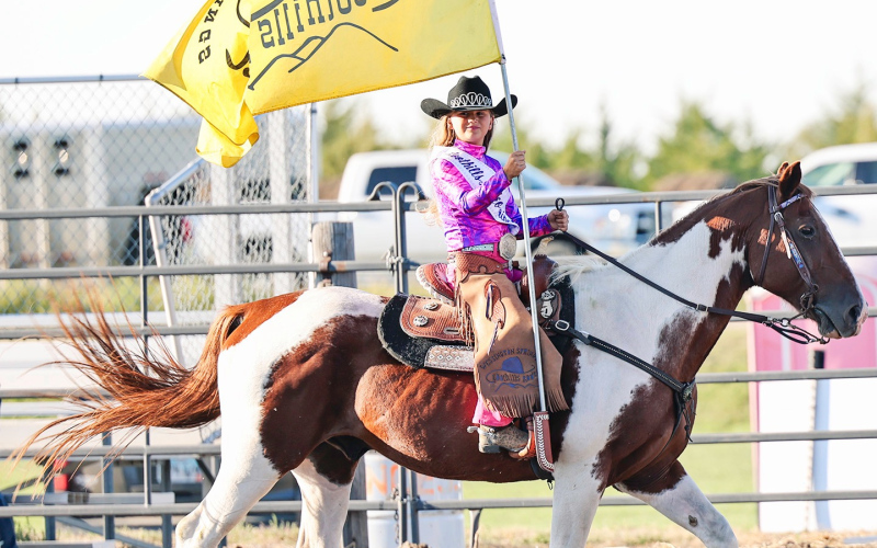 Foothills Rodeo Princess Koral Kroeplin carries the Wessington Springs arena flag during the National Anthem.