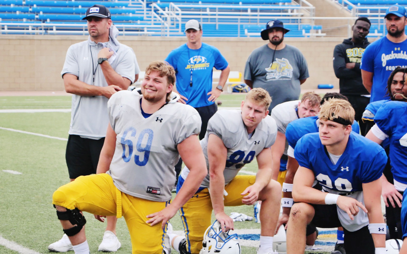 Quinten Christensen (69) has emerged as a captain and leader for South Dakota State since the arrival of Coach Dan Jackson (left, behind Christensen) this season.  Matt Zimmer/Sioux Falls Live