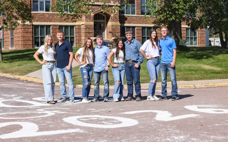 Homecoming king and queen candidates for Wessington Springs High School, Kerstynn Heim, Parker Graff, Logan Mohling, Tregen Jensen, Remie Roduner, Max Klein, Addyson Orth and Luke Larson stand in front of WSHS Monday morning after carrying out a longstanding tradition of whitewashing the streets by the schools and along Main Street on Sunday night. Just as the fresh coat of white stands the test of time throughout the fall season, so too does the tradition of Homecoming royalty in Wessington Springs.