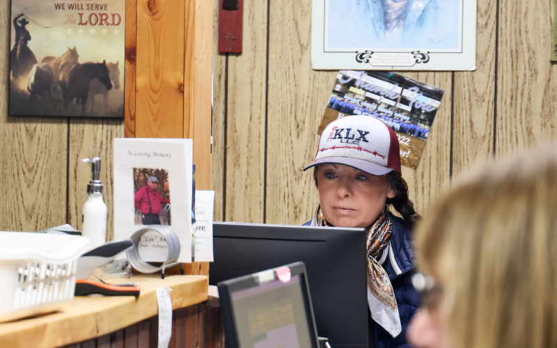 Christy Christensen at her desk preparing for sale day.