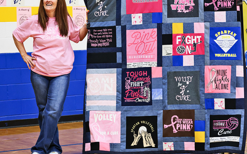 Lynn Damm served as the mentor for Remie Roduner’s senior project. She stands with the donated quilt made by Donna Grieve.