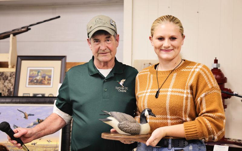 Kenzee Schafer was recognized for her decades-worth of paintings she has donated to the banquet, raising tens of thousands of dollars for the organization. She is shown with Tom Mebius.