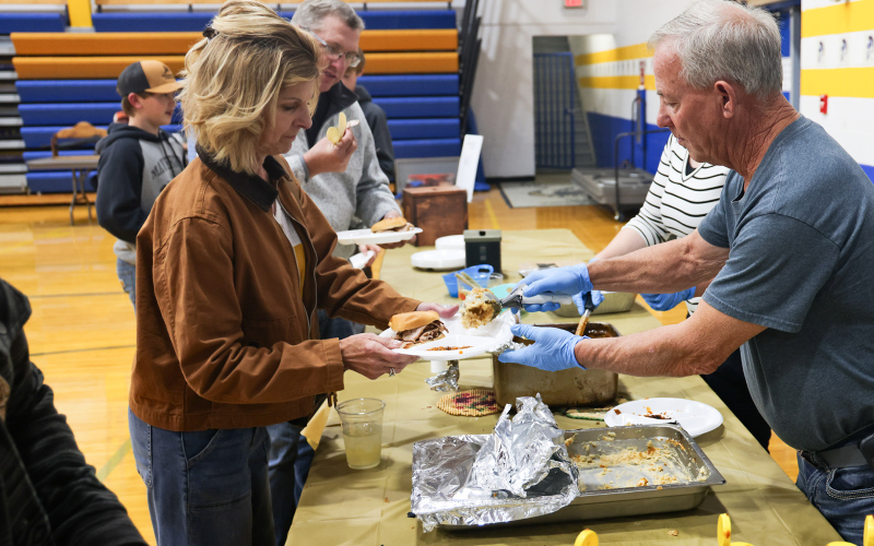 Jay Ball dishes up supper for Kim Burg.