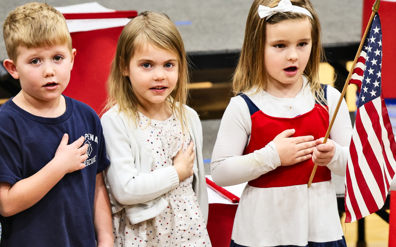 Stocktyn Schweitzer, Hazel Schroeder and Hailey Hasty are among the pre-schoolers who led the Pledge of Allegiance during Tuesday’s Veterans Day program. (KRISTI HINE / TRUE DAKOTAN)