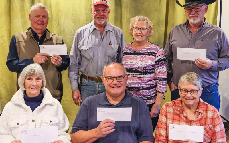 On Monday, November 17, 2025, Hub and Laura Kieser presented several checks to local organizations in memory of Hub’s mother, Gladys Kieser, who passed away one year ago. Representing the organizations are, front row, left to right: Delia Atkinson (Springs Area Bus), Rod Huisman (Blue Bag Nutrition Program), Eileen Woodruff (Jerauld County Museum). Back row: Brian Bergeleen (Opera House), Hub and Laura Kieser, Phil Wipf (Kyle Evans Western Heritage Center). (KRISTI HINE / TRUE DAKOTAN)