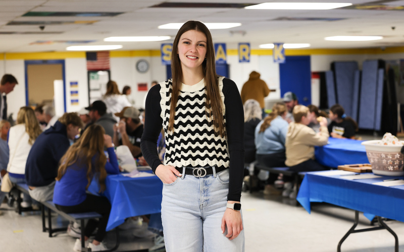 Wessington Springs High School senior Addyson Orth is pictured in the elementary school lunchroom during her senior project fundraiser, which raised more than $7,000 to support the Blue Bag Program and help address food insecurity. (KRISTI HINE / TRUE DAKOTAN)