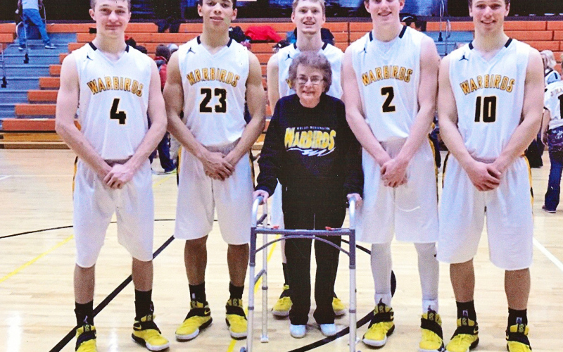 A moment of kindness shown nearly a decade ago has come full circle through a meaningful gift from the Gildemaster family, honoring the bond formed between Carol Gildemaster and the Wolsey-Wessington Warbirds basketball team during the 2016–2017 season. Shown left to right with Carol Gildemaster at center are Warbird seniors from the 2016-2017 basketball team Austin Kemnitz, Darian Ogunjemilusi, Riley Gohn, Bennett White, Darin Tschetter. Tanner Zemlicka was also a senior that year, he is not pictured.