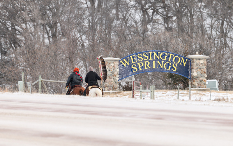 Riders participating in the Makatoh Reconciliation and Healing Horse Ride enter Wessington Springs from South Dakota Highway 34 on Friday, marking a long-standing stop in the community’s role as a host along the sacred winter journey. (KRISTI HINE / TRUE DAKOTAN)