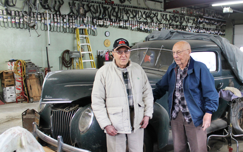 Dayle Winter (left) visits with longtime friend and fellow repairman Lloyd Kraft inside Winter Service. Winter and Kraft were classmates in the Wessington Springs Class of 1953 and both spent decades operating repair shops in the community. (PHOTO BY CRAIG WENZEL)