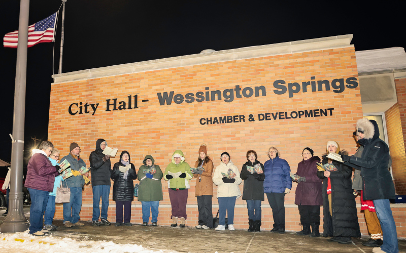 Members of the Wessington Springs Community Choir brave the cold to sing during the community tree lighting.