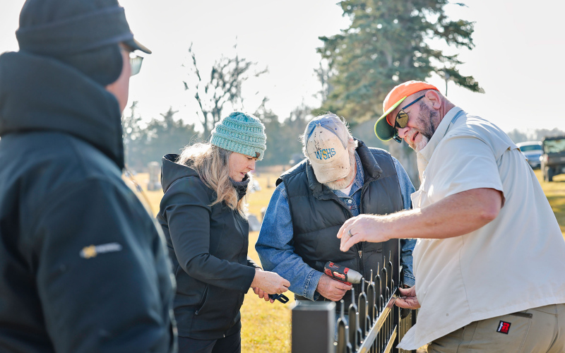 Dale and Melissa Schimke, Tom Dean and Rick Couch assist with fence installation at Hope Cemetery as part of the community-led improvement effort. Additional volunteers integral to the project were Katie Deneke, Herman Eilers, Darrell Deneke, Eileen Woodruff and Duane Deneke. Volunteers were also sustained with meals made by Norma Powell and Pat Eagle, preparing sandwiches and bringing chips for the crew as the work continued.