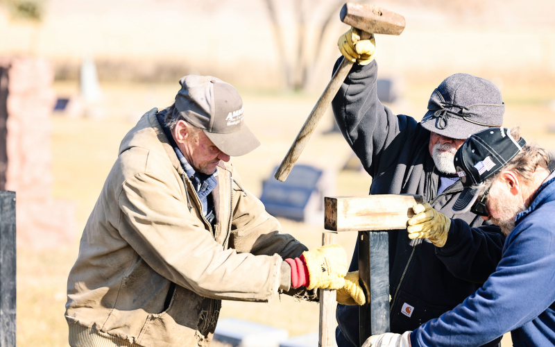 Volunteers work together during one of several workdays to complete the new fence at Hope Cemetery. Community members contributed time, labor and equipment throughout the project. Pictured (left to right) are Larry Powell, Phil Campos and Ron Thompson.