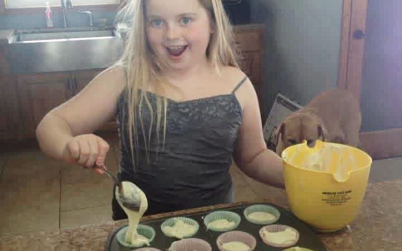 Emma Haeder is pictured as a young girl baking — a passion she says has always been part of her life. That early love of baking has since grown into Miss Rosalie’s Sweets and Treats, a business that launched this summer and has quickly found strong community support. (COURTESY PHOTO)