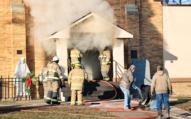 Smoke billows from the front entrance of St. Joseph Catholic Church in Wessington Springs Friday morning as firefighters work at the scene after a fire was reported shortly after 9 a.m. (KRISTI HINE / TRUE DAKOTAN)