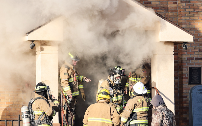 Smoke billows from the front entrance of St. Joseph Catholic Church in Wessington Springs Friday morning as firefighters work at the scene after a fire was reported shortly after 9 a.m. (KRISTI HINE / TRUE DAKOTAN)