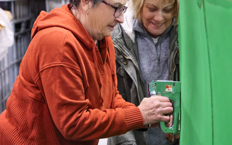 Karen Clarke and Patty Schilling work on decorating their float in preparation for Saturday's Wessington Parade of Lights.