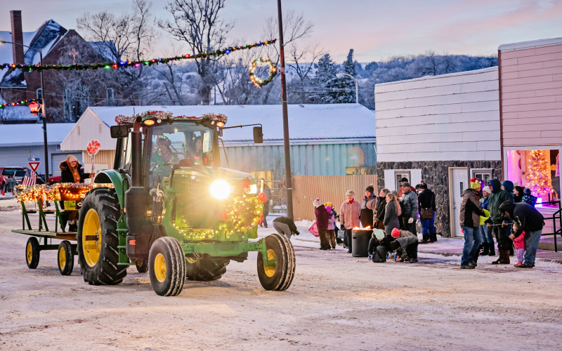 A Parade of Lights featuring a tractor, decorated golf carts and UTVs brought the cheer. Kimberly Ahrenstorff and Teresa Fonder are pictured inside the cab with Jerry Caffee and Riaan Jansen van Vuuren following on foot with candy.