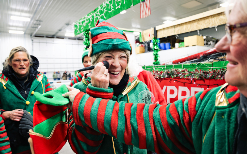 Patty Schilling applies "elf blush" before the parade.