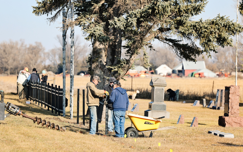 Volunteers install new fencing at Hope Cemetery as part of ongoing preservation and improvement efforts aimed at honoring the cemetery’s history while ensuring its care for future generations. The original entrance to Hope Cemetery has been carefully preserved, maintaining a visible connection to the site’s history and the generations it serves.