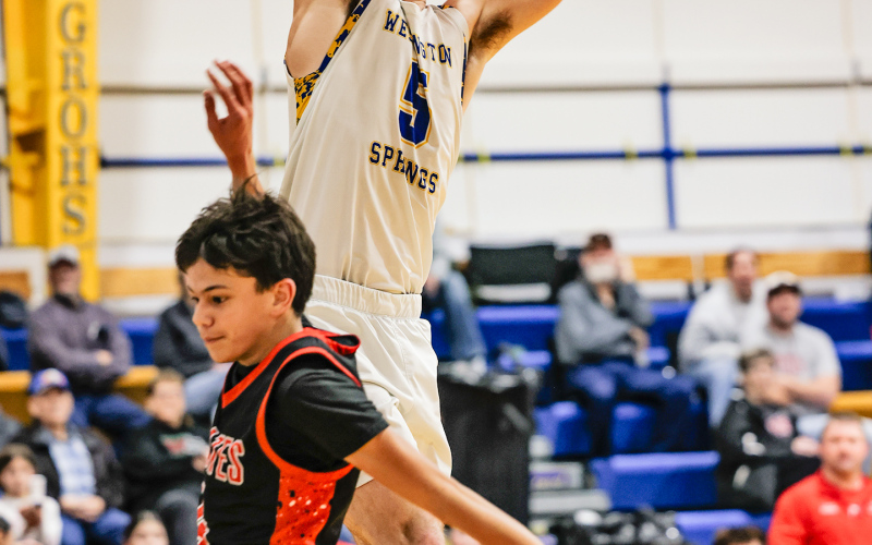 Wessington Springs’ Colby Flowers hangs on the rim as his dunk drops through the net during the Spartans’ 70–38 win over Highmore-Harrold on Saturday, Jan. 3. (KRISTI HINE / TRUE DAKOTAN)