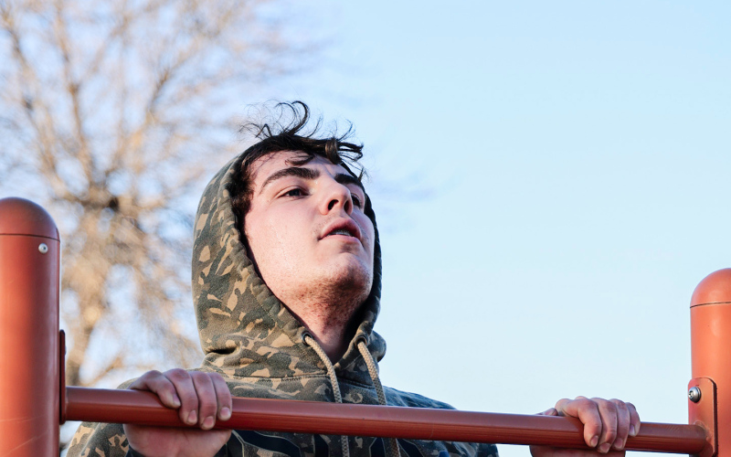 Ethan Rearick powers through pull-ups at the city park during an outdoor workout session as the Warhawks fine-tune their conditioning.