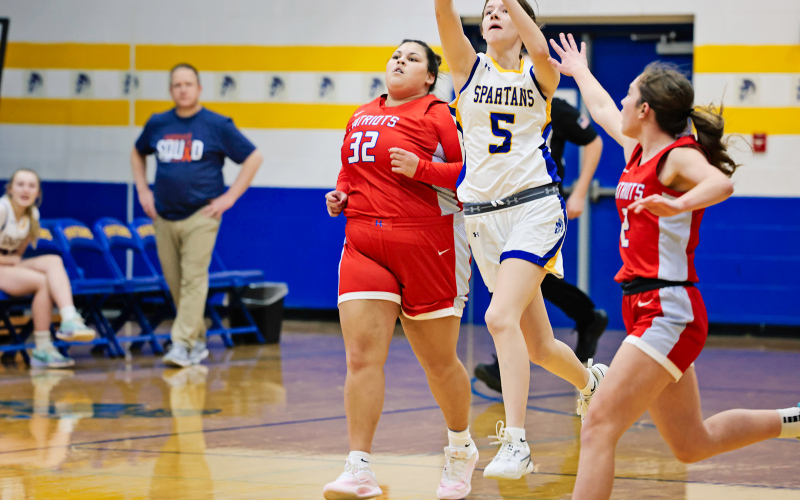 Masynn Mebius launches a half-court shot at the buzzer to end the first quarter, giving the Spartans the lead in a back-and-forth battle with Hitchcock-Tulare. (KRISTI HINE / TRUE DAKOTAN)