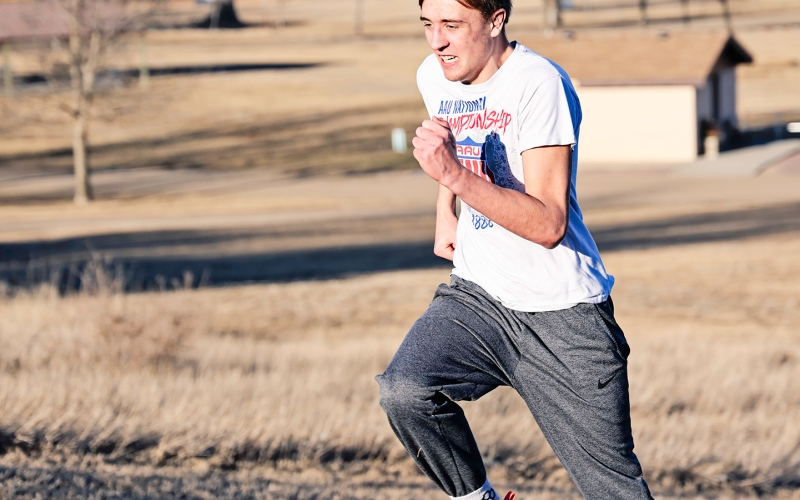 Carson Finn sprints up the ski hill during an outdoor workout.