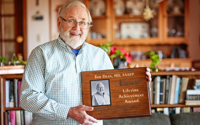 Dr. Tom Dean holds the Lifetime Achievement Award he recently received from the South Dakota Academy of Family Physicians at his home in Wessington Springs. The award recognizes his decades of service to family medicine, rural health and health policy.